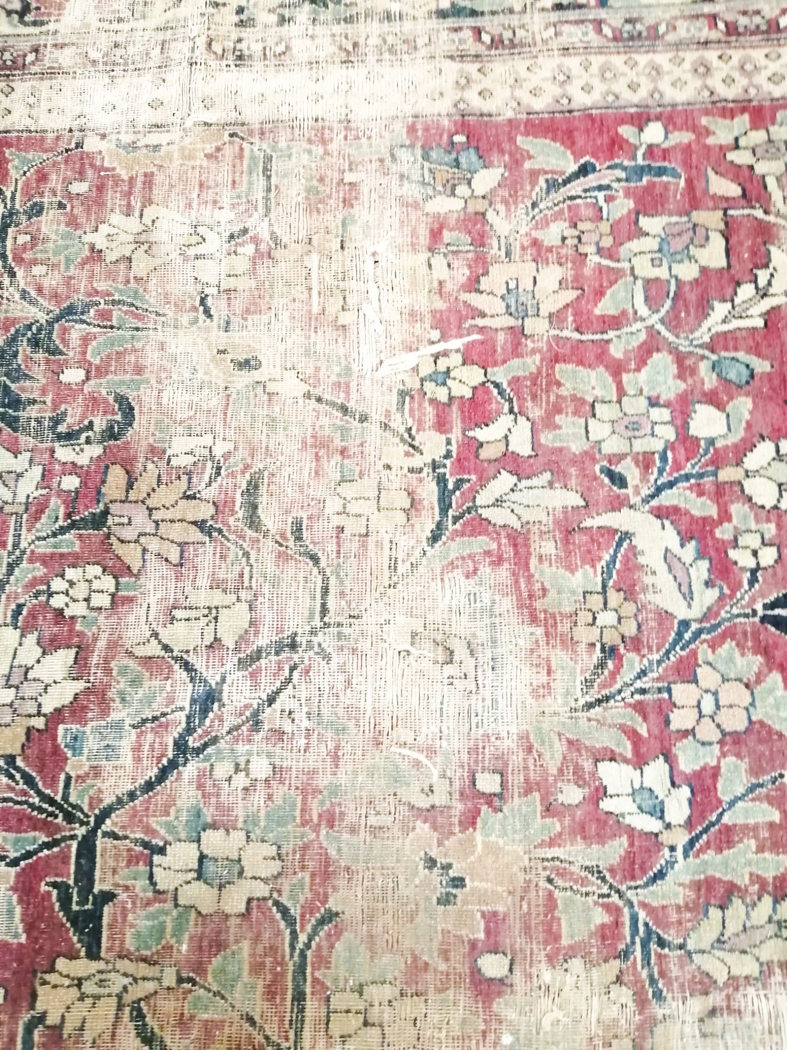 An antique Kashan blue ground carpet (worn and holed) 410 x 300cm